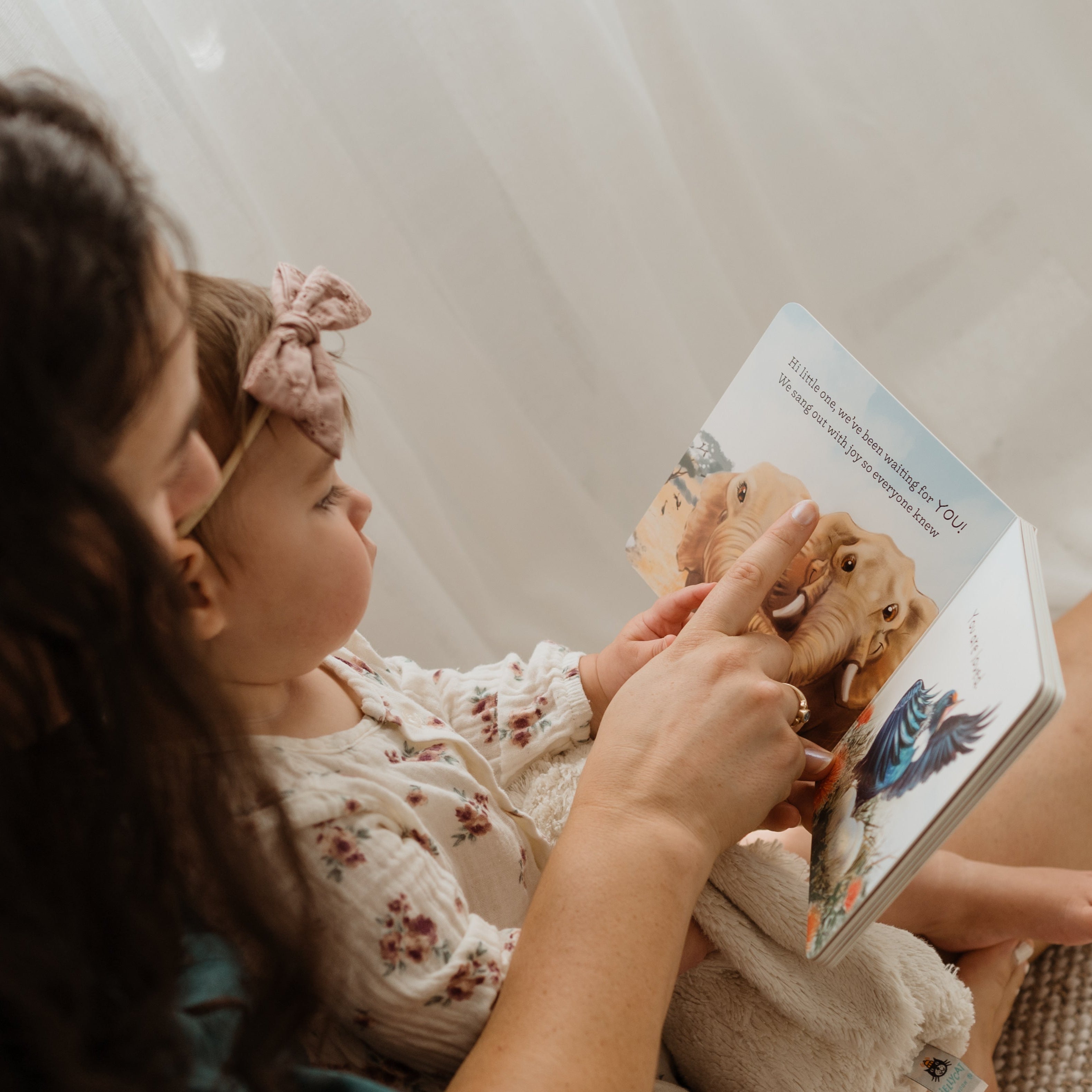 Mother reading a book together on a couch